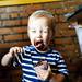 Nineteen-month-old Arlo Maynard eats vegan chocolate rain ice cream from Go! Ice Cream during the Shadow Art Fair at the Corner Brewery in Ypsilanti on Saturday, July 20. Daniel Brenner I AnnArbor.com
